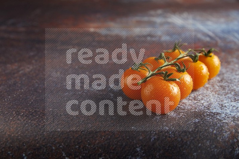 Orange cherry tomato vein on reddish rustic metal background 45 degree