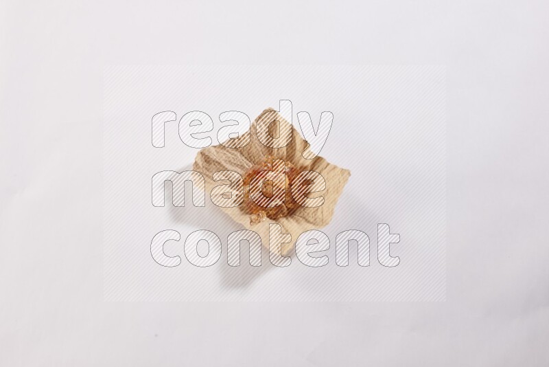 A crumpled piece of paper full of gum arabic on white flooring