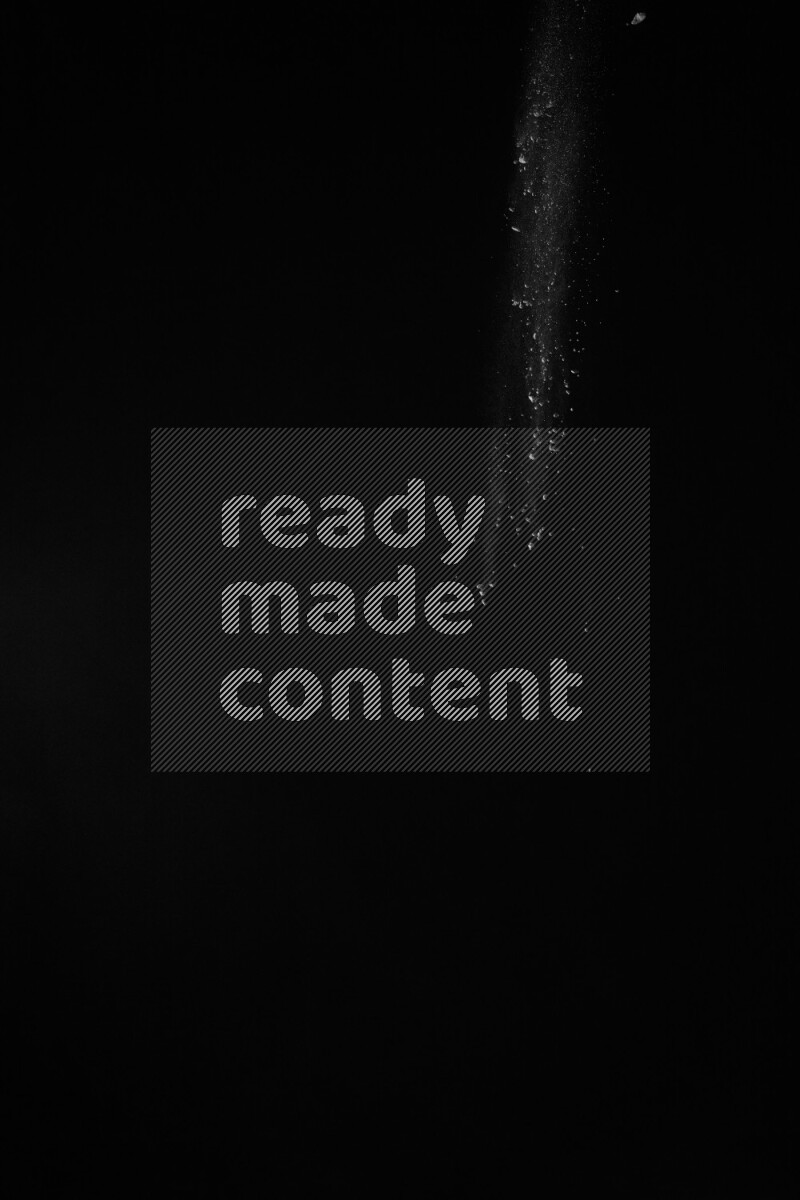 A side view of white powder explosion on black background