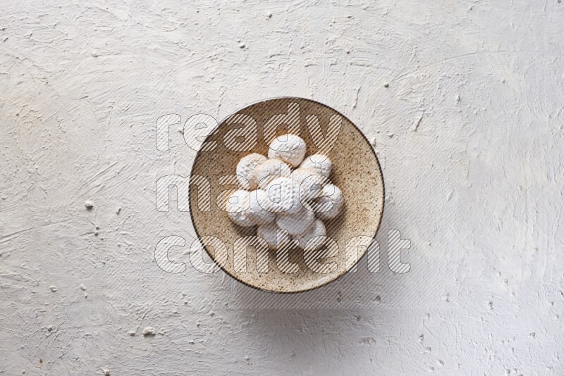 Kahk on a serving plate on a white background