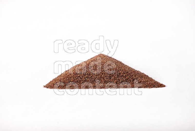 Garden cress seeds in a triangle shape on a white flooring