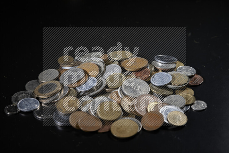 A close-ups of random old coins on black background