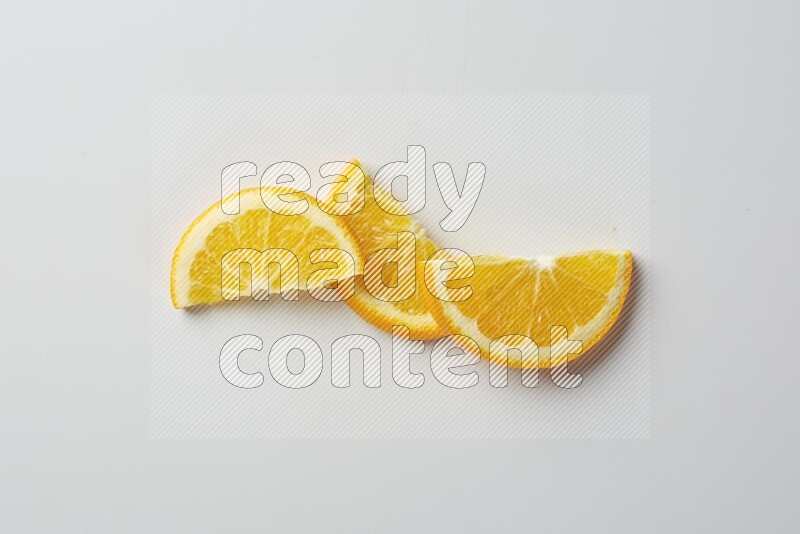 Three halves of an orange slices on white background