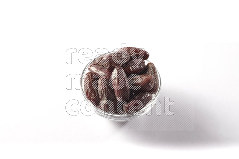 Dates in a glass bowl on white background