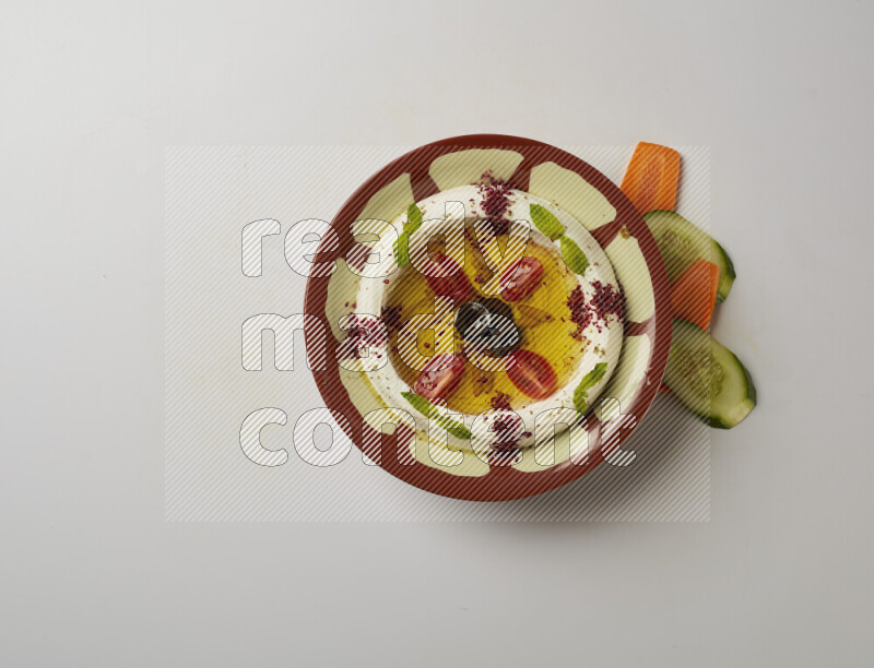 Lebnah garnished with Cherry tomato, mint & sumak  in a traditional plate on a white background