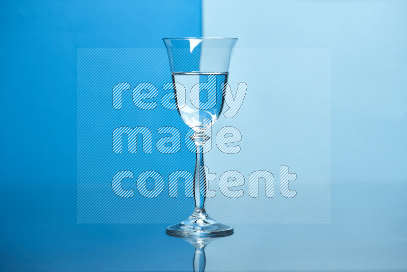 The image features a clear glassware filled with water, set against blue and light blue background