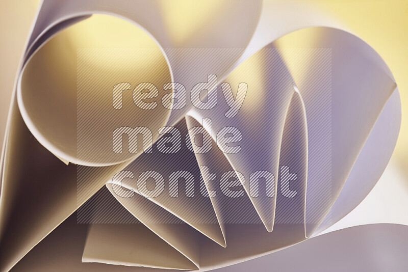 An artistic display of paper folds creating a harmonious blend of geometric shapes, highlighted by soft lighting in white and gold tones