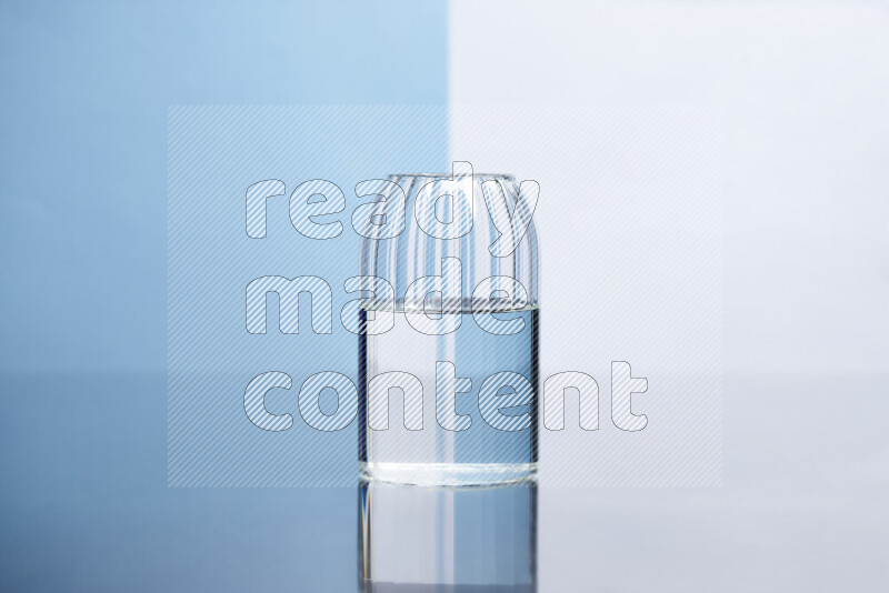 The image features a clear glassware filled with water, set against white and light blue background