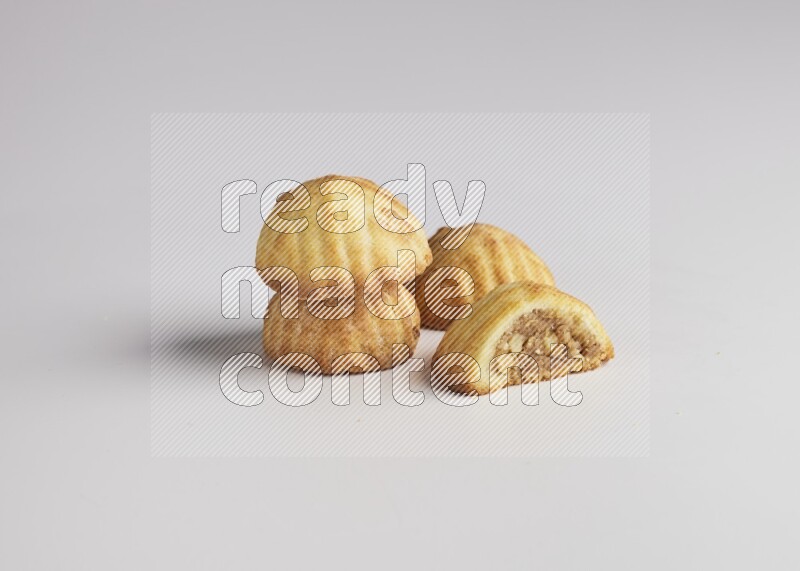 Four Pieces of Maamoul filled with walnut paste  one of them is cut direct on white background