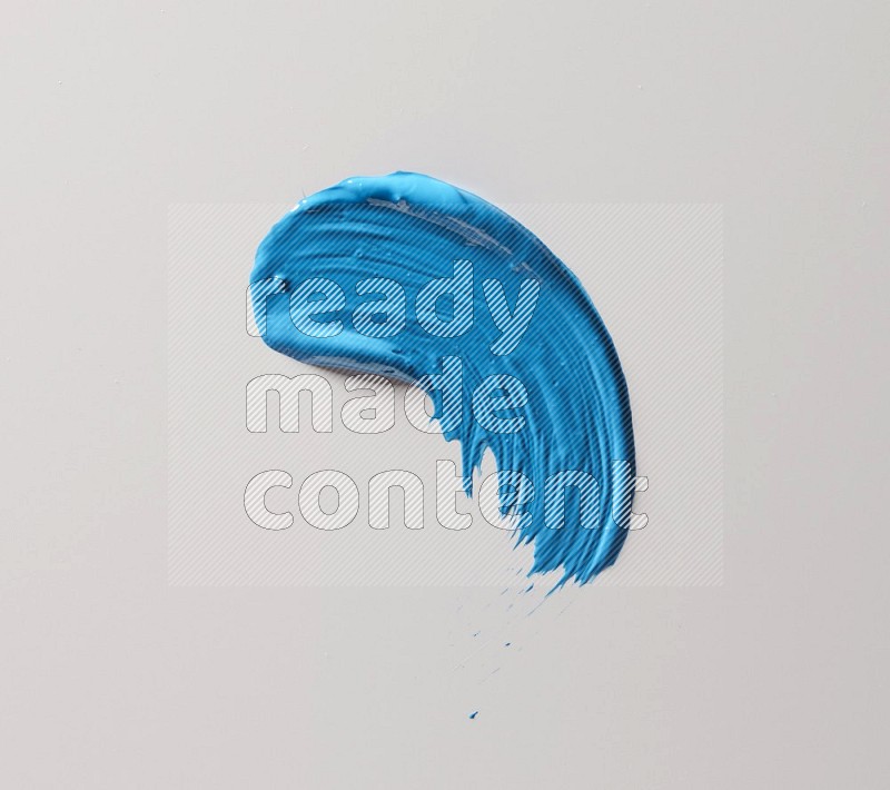 A single blue curved brush stroke on a white background
