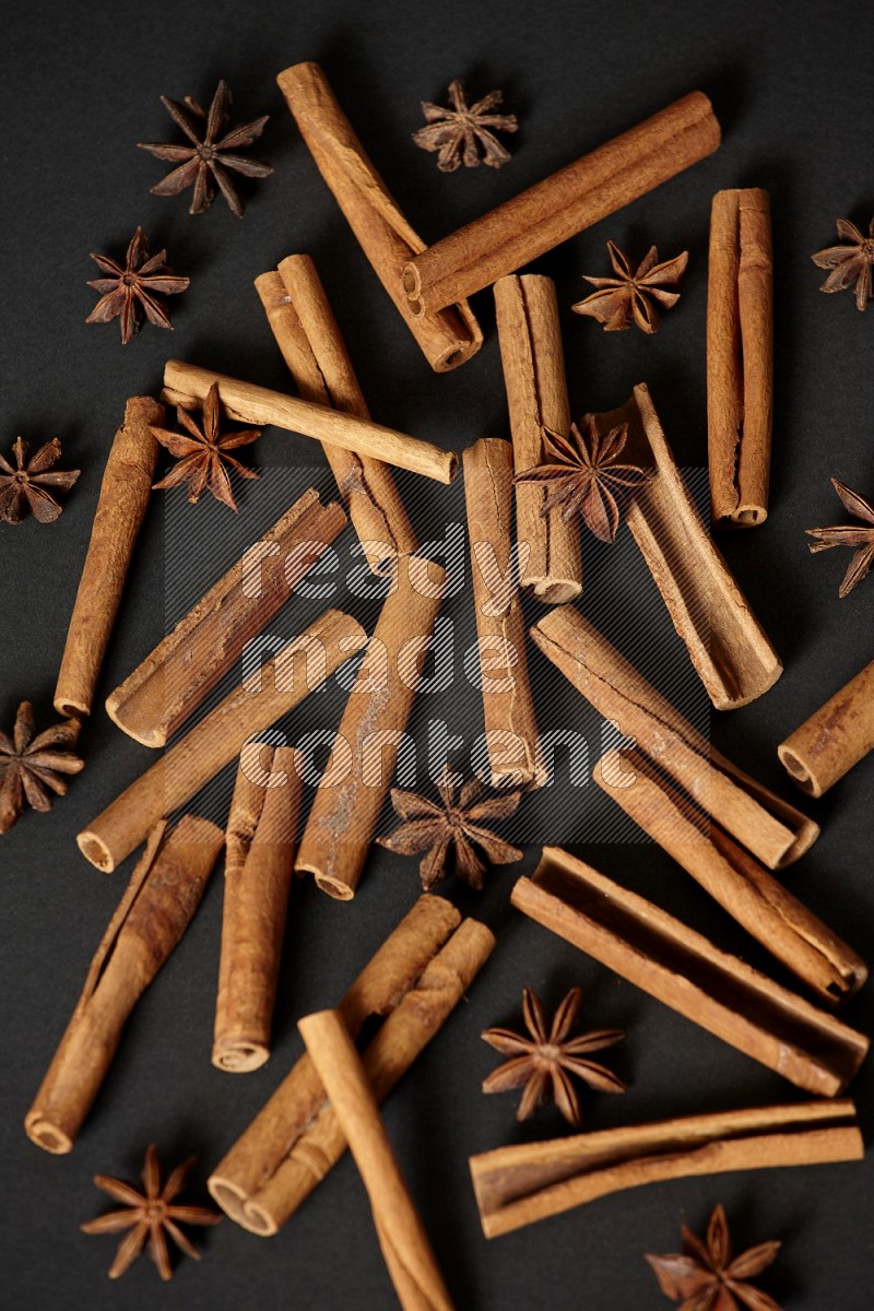 Cinnamon sticks and star anise on black background