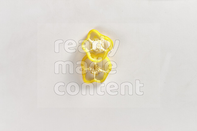 Yellow bell pepper slices on white background