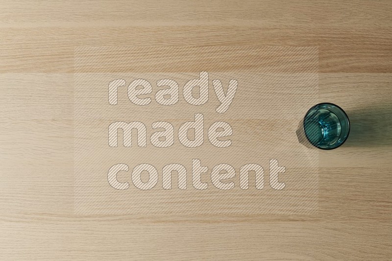 Top View Shot Of A Turquoise Glass on Oak Wooden Flooring