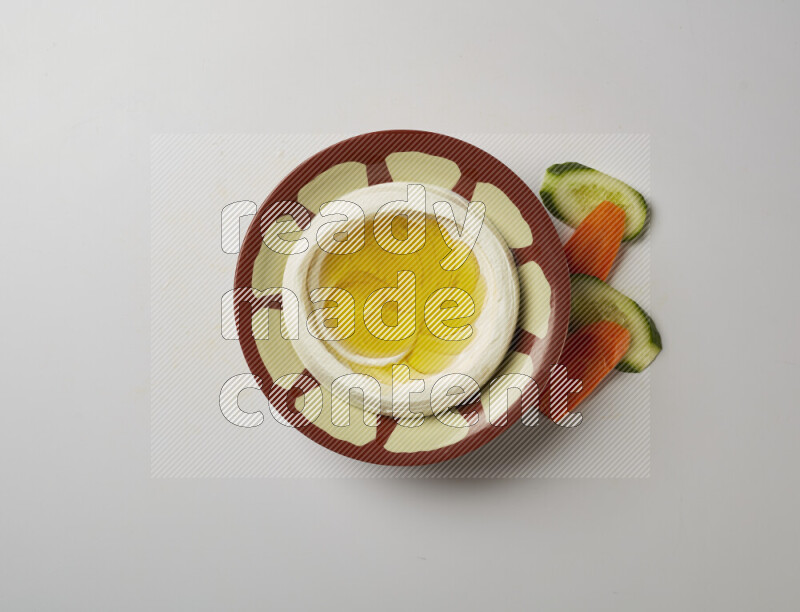 Lebnah garnished with olive oil in a traditional plate on a white background