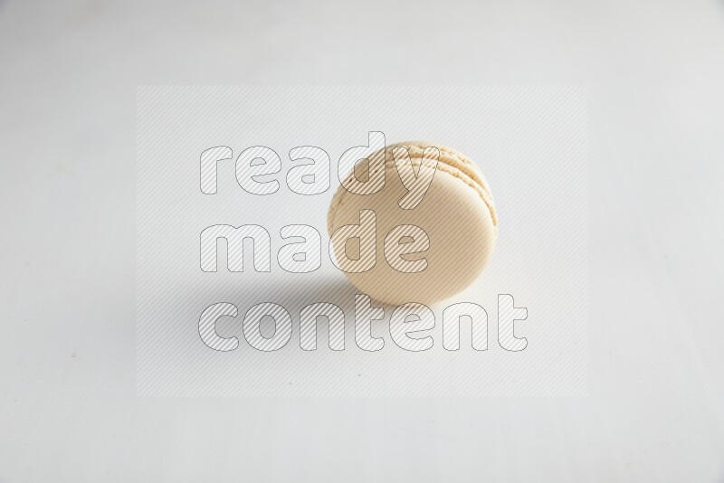 45º Shot of White Caramel fleur de sel macaron on white background