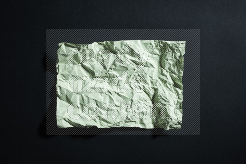 Green paper sheet on black background
