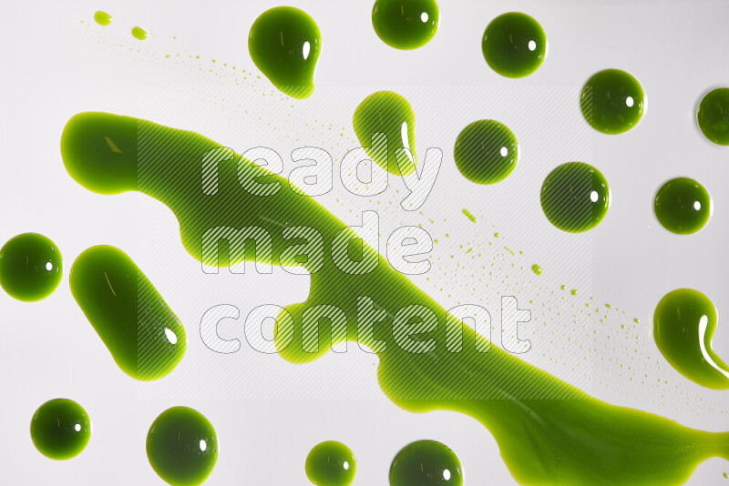 Close-ups of abstract green paint droplets on the surface