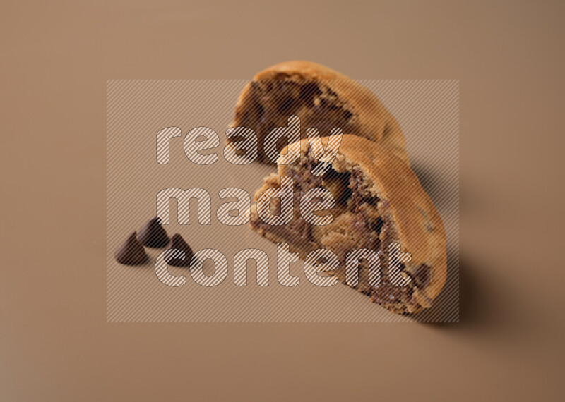 a cookie cut in half on a brown background