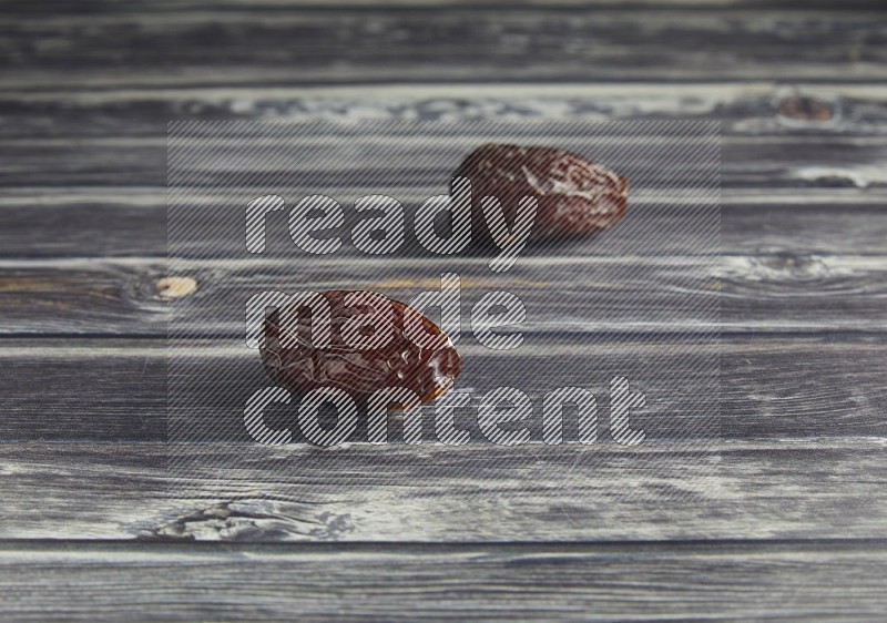 two madjoul dates on a wooden grey background