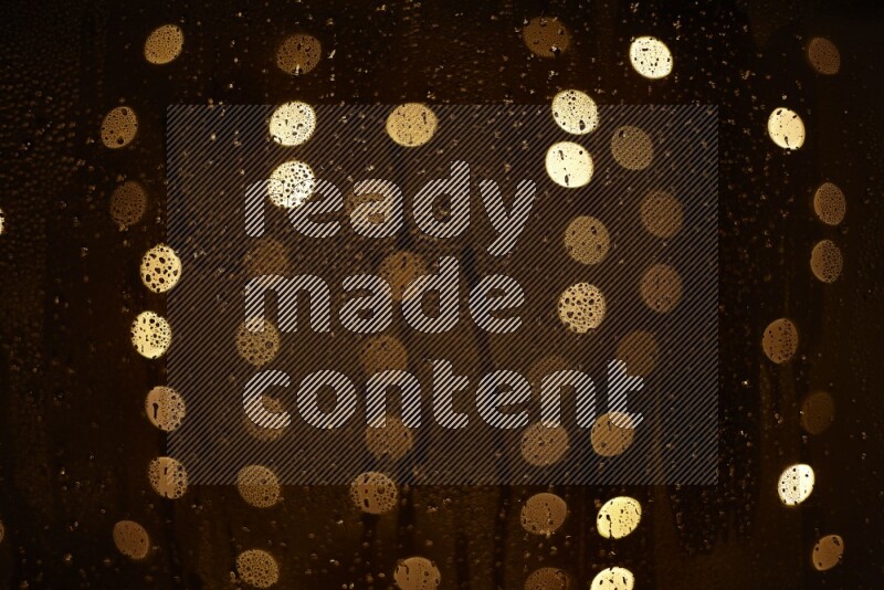 Bokeh light in yellow with water drops