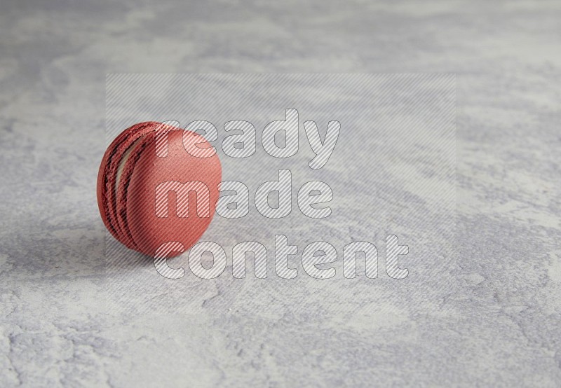 45º Shot of Red Velvet macaron on white  marble background