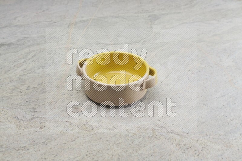 A multicolored pottery bowl on grey marble background