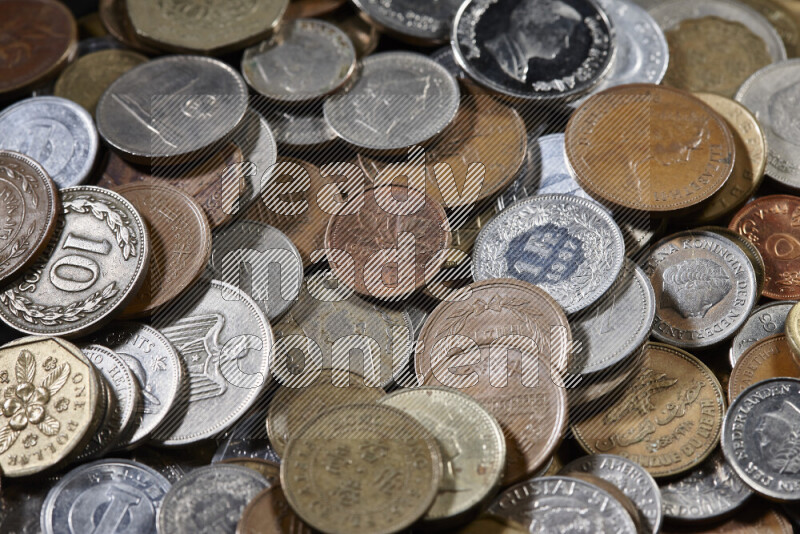 A close-ups of random old coins on black background