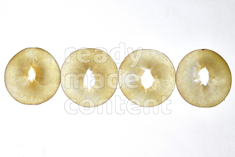 Peach slices on illuminated white background