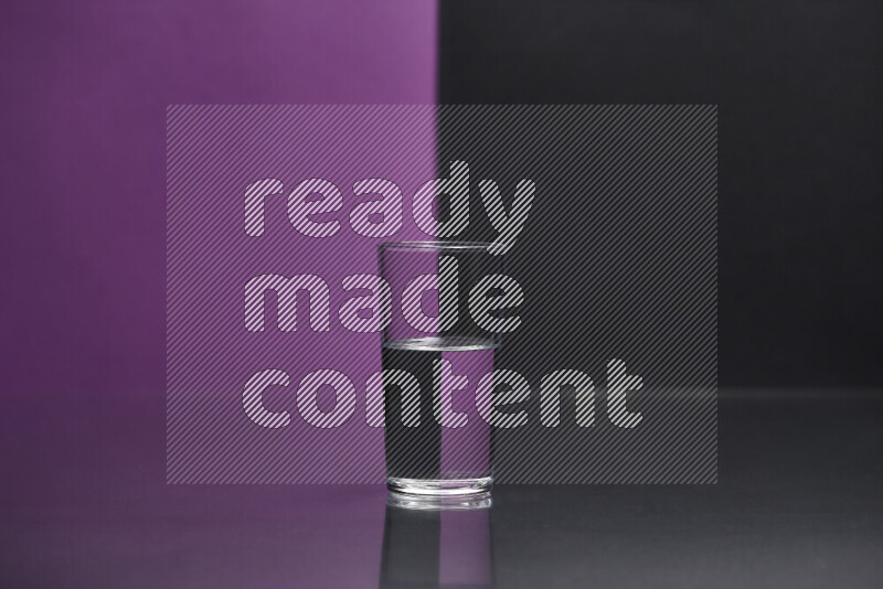 The image features a clear glassware filled with water, set against purple and black background