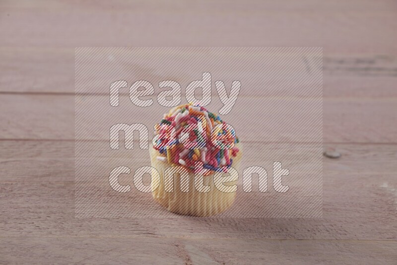 Vanilla mini cupcake topped with sprinkles