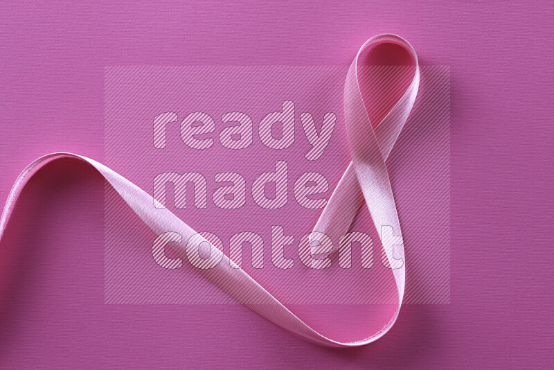 Cancer awareness ribbons on pink background