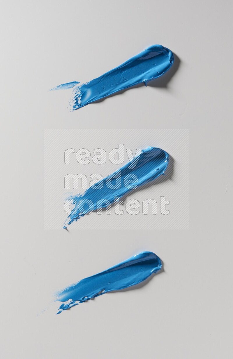 Blue painting knife strokes on white background