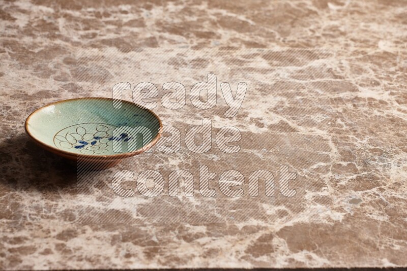 Decorative Pottery Plate on Beige Marble Flooring