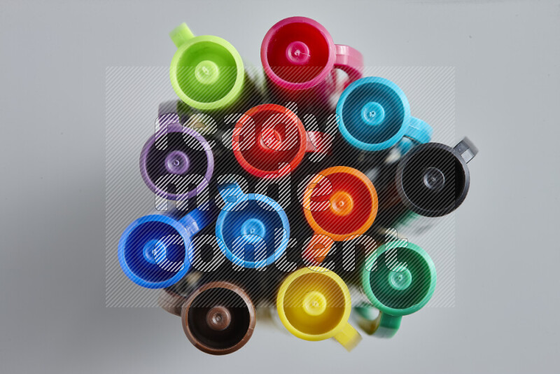 The image captures top view shot of colored caps on grey background