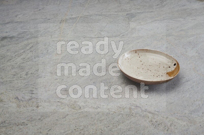 Multicolored Pottery Plate On Grey Marble Flooring