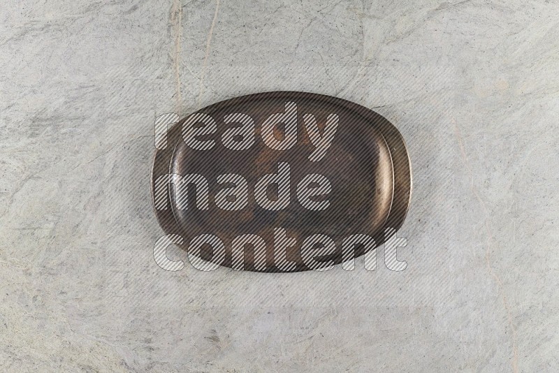 Top View Shot Of A Vintage Metal Tray On Grey Marble Flooring