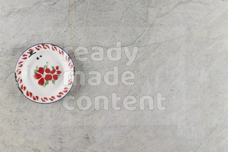A vintage metal plate on grey marble background
