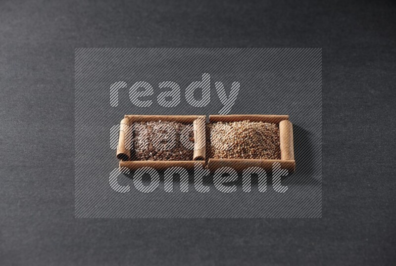 2 squares of cinnamon sticks full of mustard seeds and flaxseeds on black flooring
