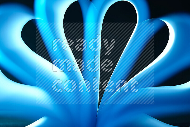 An abstract art piece displaying smooth curves in white and blue gradients created by colored light