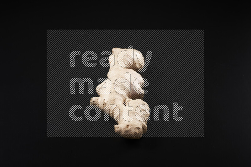 Fresh ginger root on black background