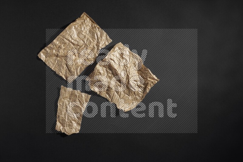 Crumpled craft paper on black background