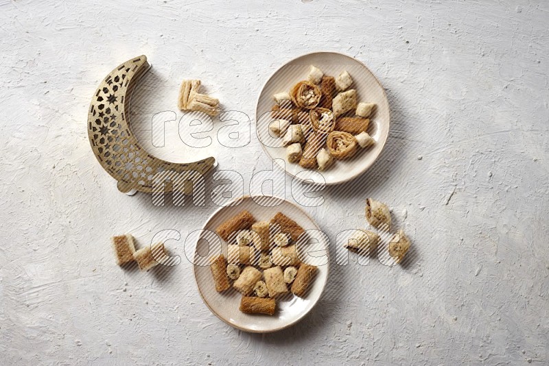 Oriental sweets in pottery plates with a lantern in a light setup