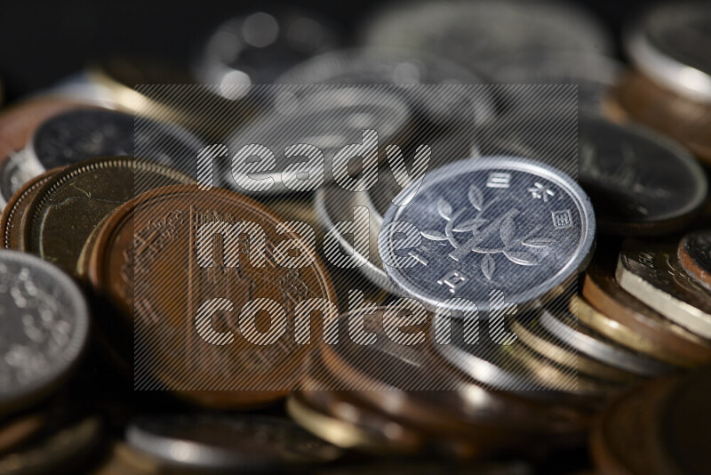 A close-ups of random old coins on black background