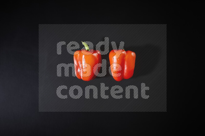 Red bell pepper on black background