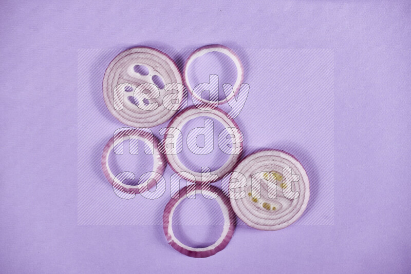 Red onions rings on purple background