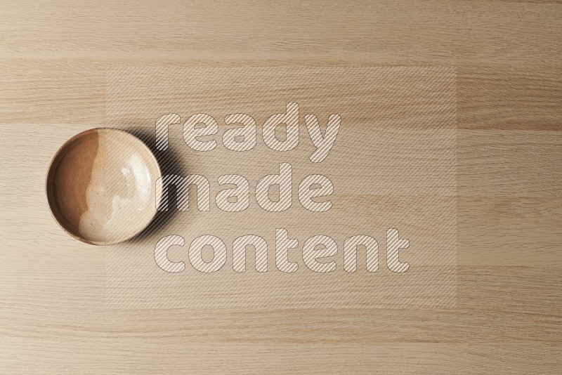 Top View Shot Of A Beige Pottery Plate on Oak Wooden Flooring