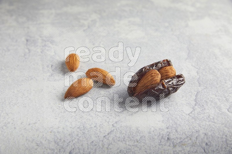almond stuffed madjoul date on a light grey background