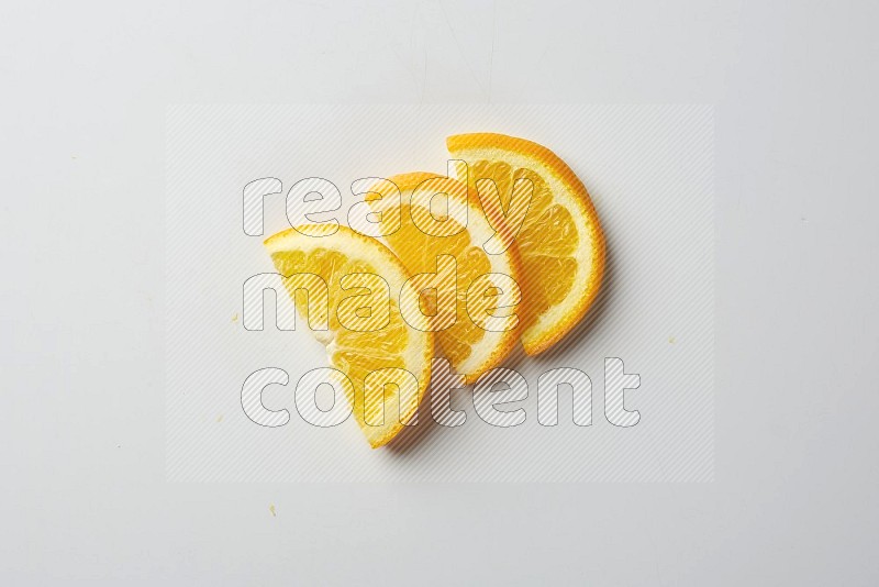 Three halves of an orange slices on white background