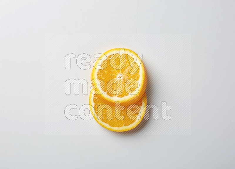 Two orange slices on white background