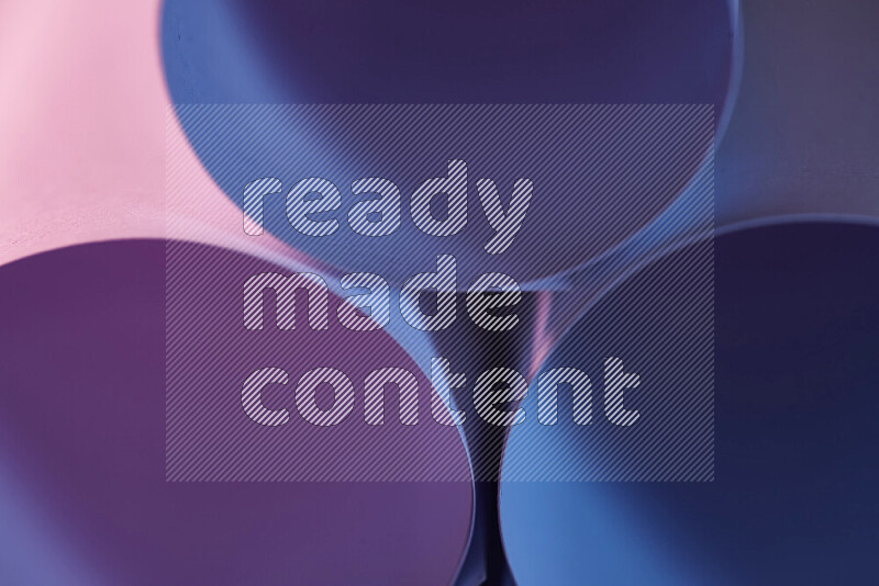 The image shows an abstract paper art with circular shapes in varying shades of blue and pink